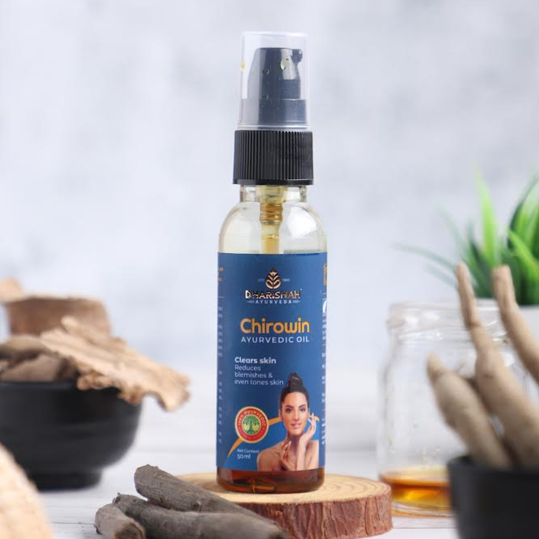 Chirowin Ayurvedic Oil by Dharishah displayed with natural ingredients on wooden surface.